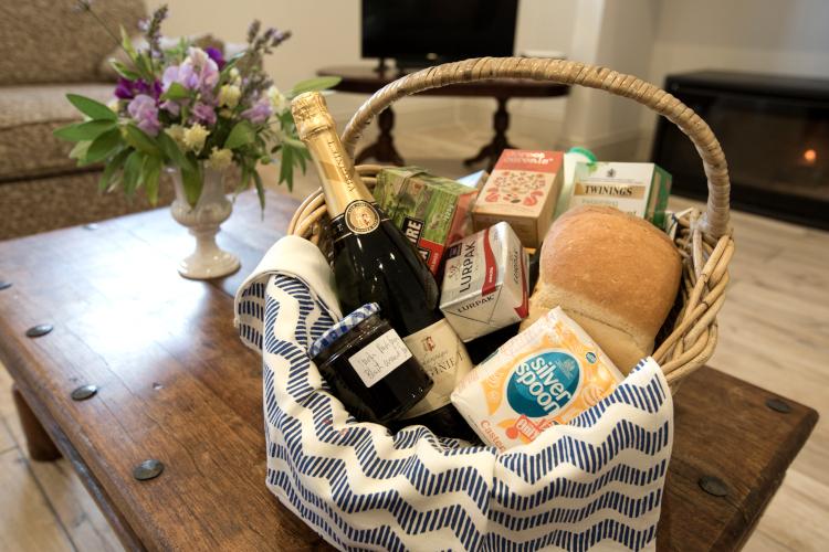 Premium welcome hamper with fruit, wine and snacks