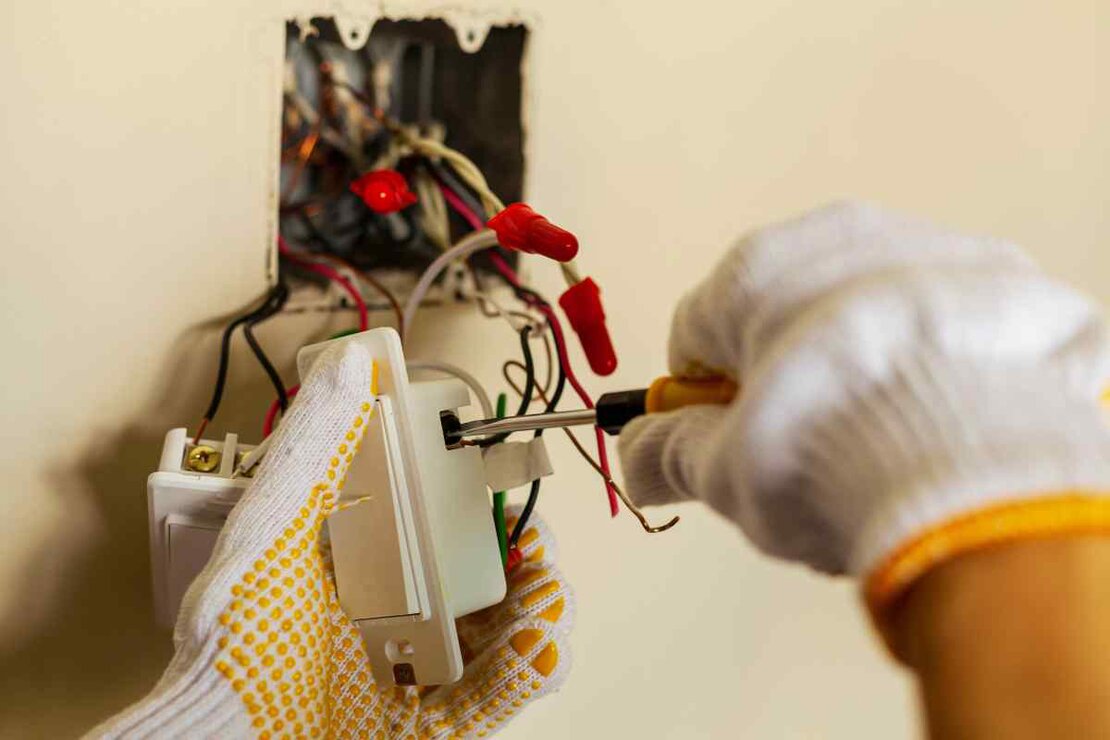 Electrician checking an electrical panel in a property