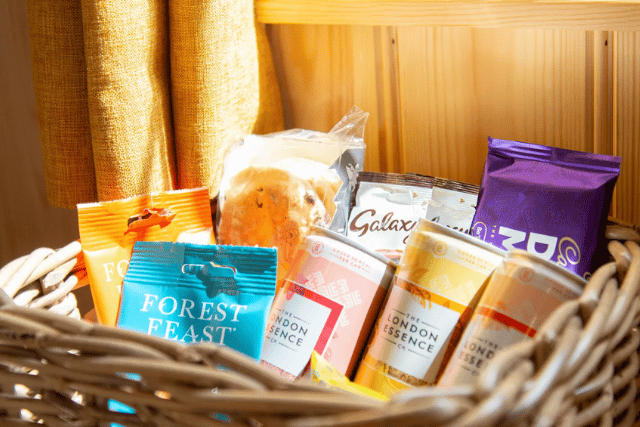 Groceries and drinks laid out as a welcome pack in a holiday kitchen